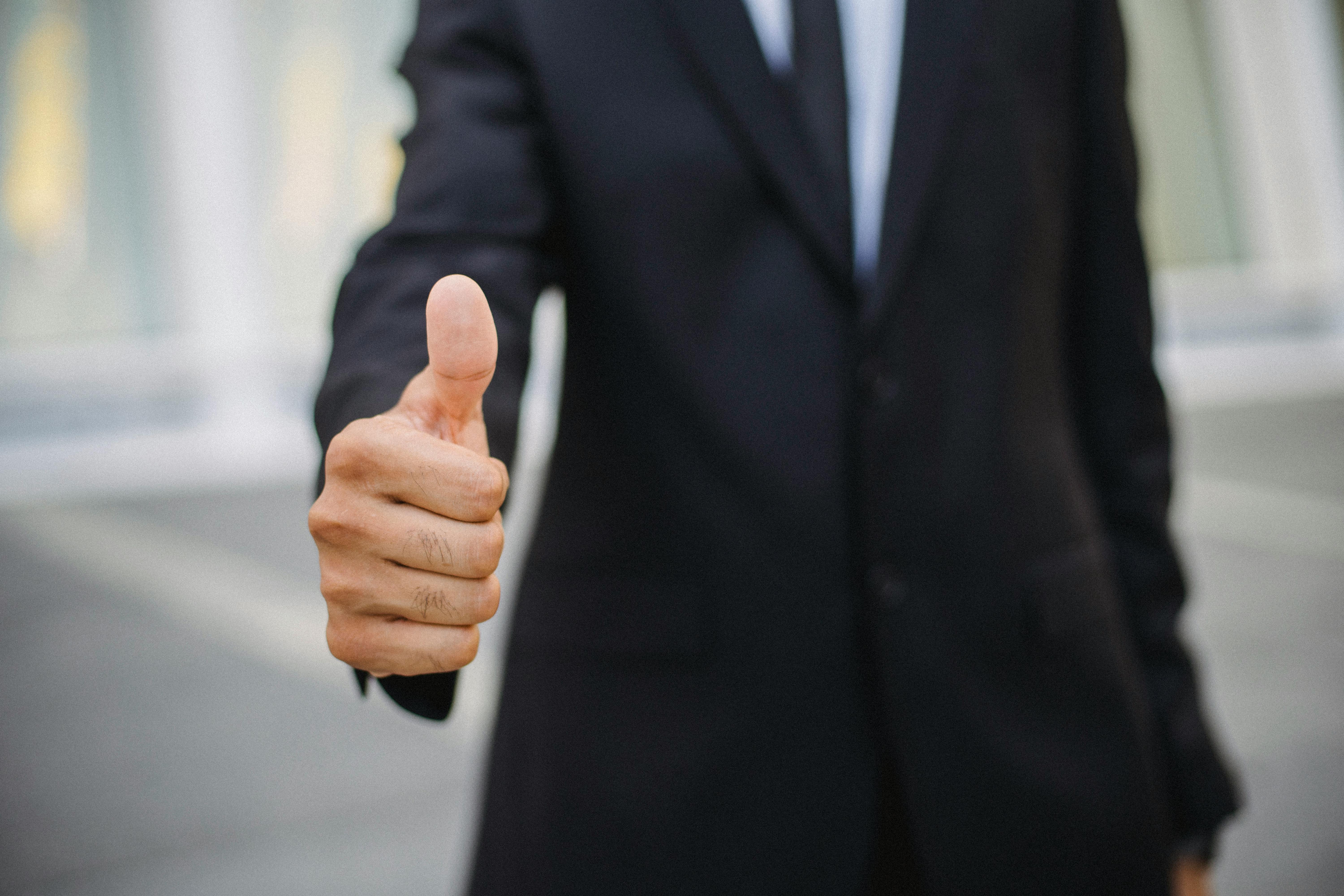 Business professional giving thumbs up